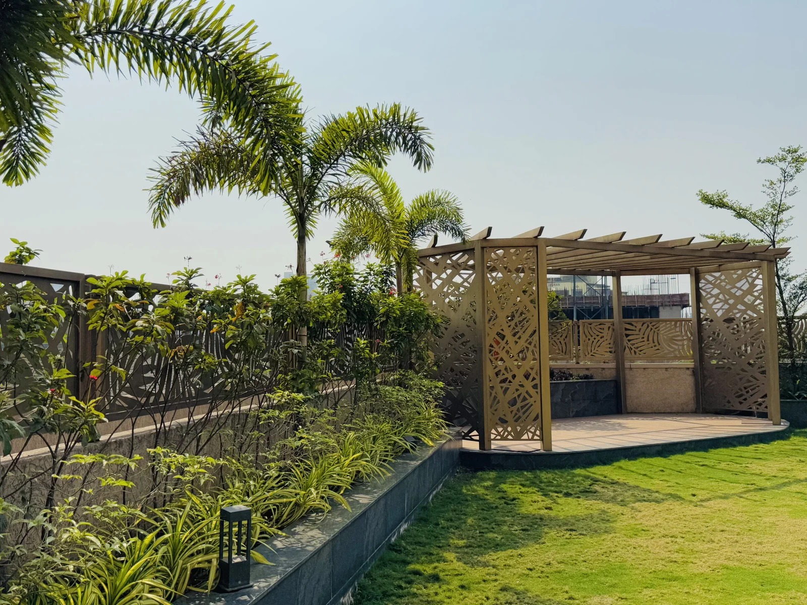Pergola with plants and palm trees